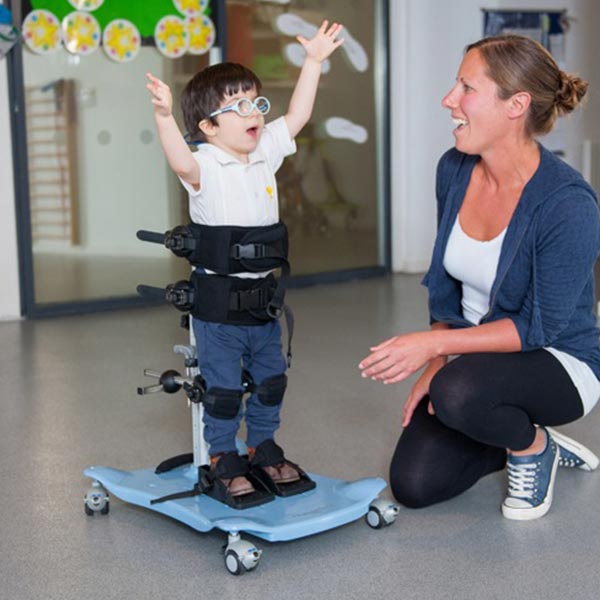 Etac/R82 Meerkat Pediatric Standing Frame child boy with caregiver