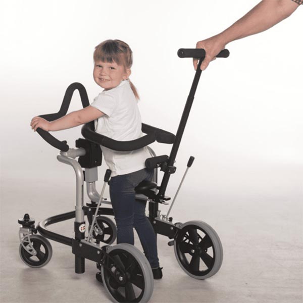 girl child using pediatric Meywalk 4 with parent holding onto safety handlebar guiding the child