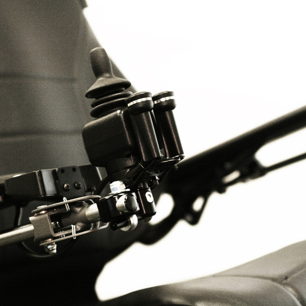 Close-up shot of the Permobil Compact Joystick, black rubber wheelchair control joystick from the left-side perspective