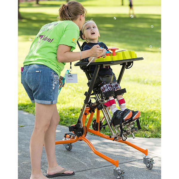 female caregiver with male child using the Prime Engineering Superstand HLT Pediatric Standing Frame
