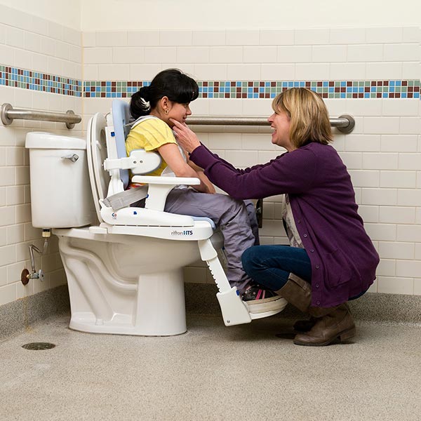 Mother and adult child using the Rifton HTS Adult & Pediatric Hygiene and Toileting System in the bathroom