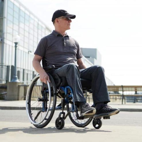 older white male sitting in wheelchair wearing sunglasses