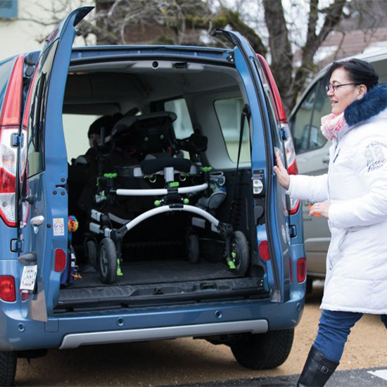 Grillo Gait Trainer being loaded into a van trunk